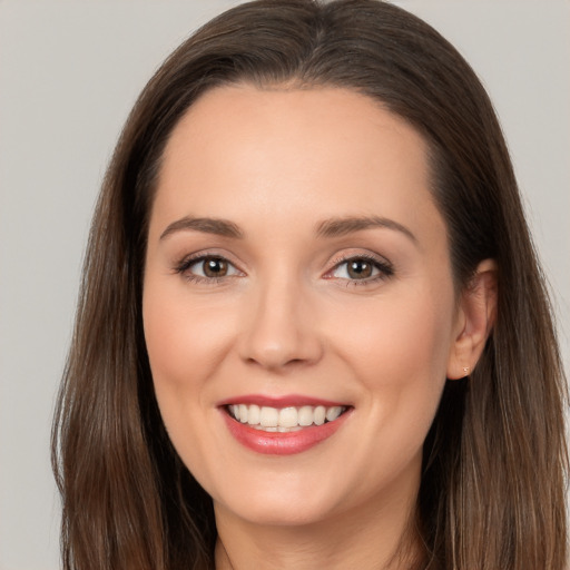 Joyful white young-adult female with long  brown hair and brown eyes