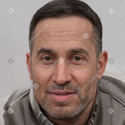 Joyful white adult male with short  brown hair and brown eyes