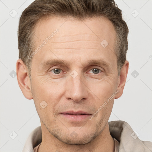 Joyful white adult male with short  brown hair and grey eyes