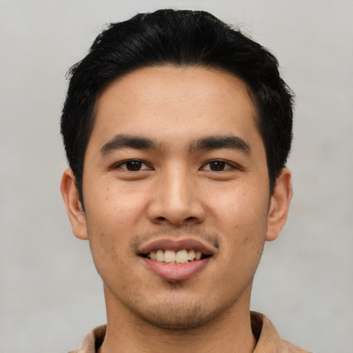 Joyful asian young-adult male with short  black hair and brown eyes
