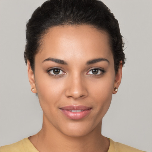 Joyful latino young-adult female with short  brown hair and brown eyes