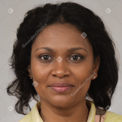 Joyful black adult female with medium  brown hair and brown eyes