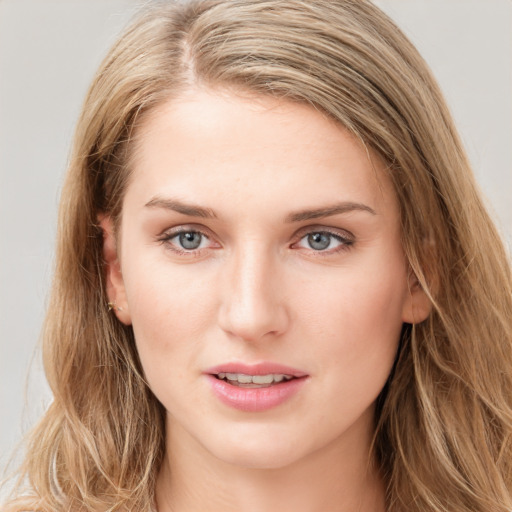 Joyful white young-adult female with long  brown hair and blue eyes