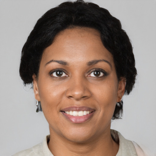Joyful black young-adult female with short  brown hair and brown eyes