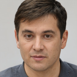 Joyful white adult male with short  brown hair and brown eyes