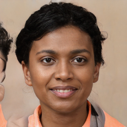 Joyful latino young-adult female with short  black hair and brown eyes
