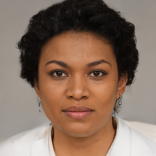Joyful black young-adult female with short  black hair and brown eyes