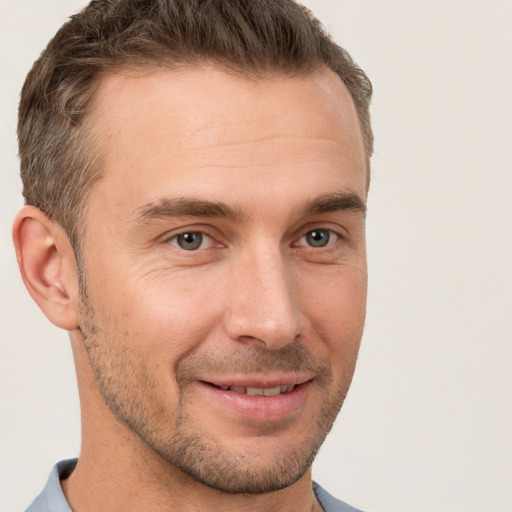 Joyful white young-adult male with short  brown hair and brown eyes