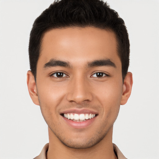 Joyful white young-adult male with short  brown hair and brown eyes