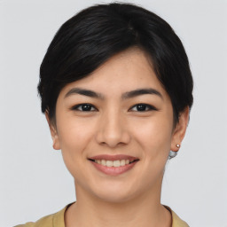 Joyful asian young-adult female with medium  black hair and brown eyes