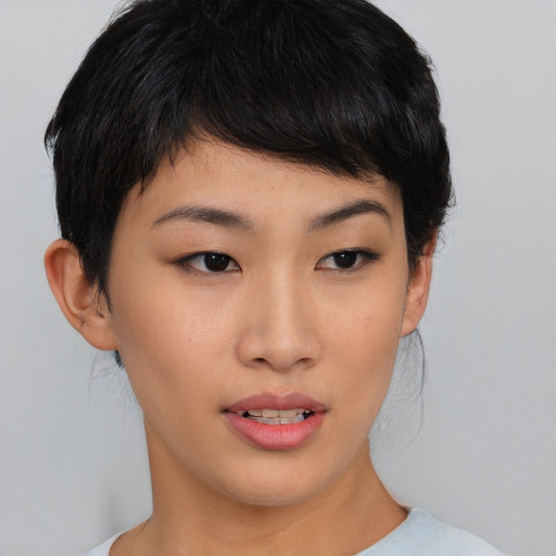 Joyful asian young-adult female with short  brown hair and brown eyes