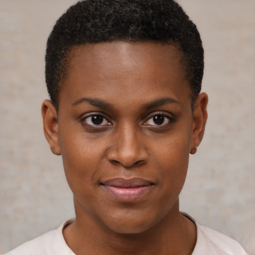 Joyful black young-adult female with short  brown hair and brown eyes
