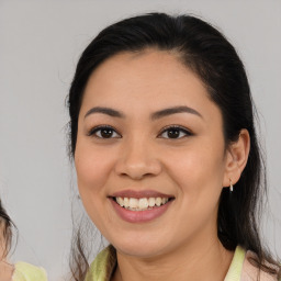 Joyful latino young-adult female with medium  brown hair and brown eyes