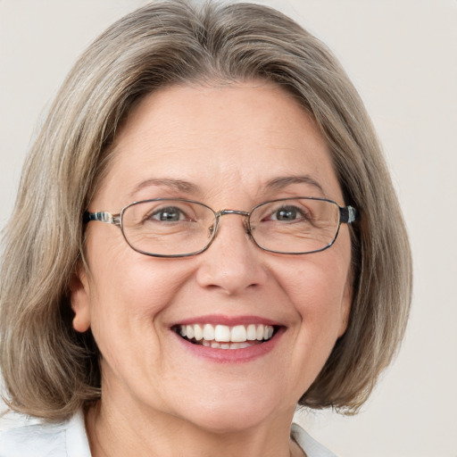 Joyful white middle-aged female with medium  brown hair and blue eyes