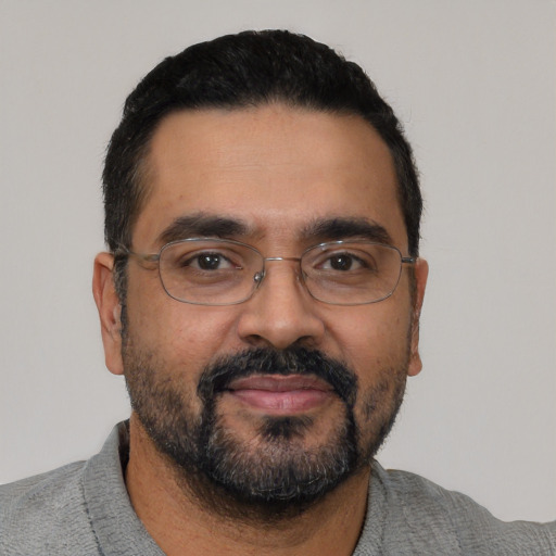 Neutral latino adult male with short  black hair and brown eyes