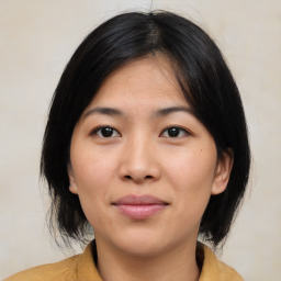 Joyful asian young-adult female with medium  black hair and brown eyes