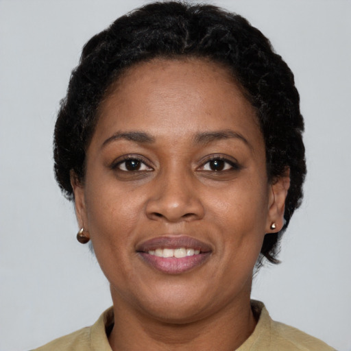 Joyful black adult female with short  brown hair and brown eyes