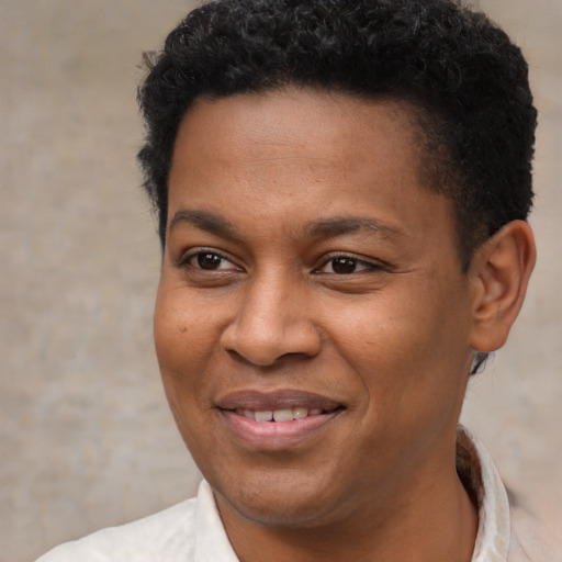 Joyful black young-adult male with short  brown hair and brown eyes