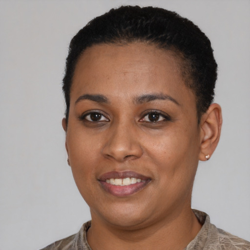 Joyful black young-adult female with short  black hair and brown eyes
