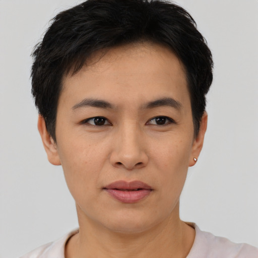 Joyful asian young-adult female with short  black hair and brown eyes