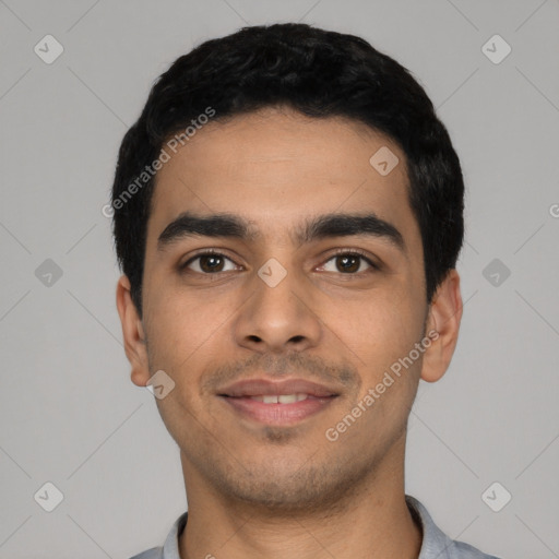 Joyful latino young-adult male with short  black hair and brown eyes