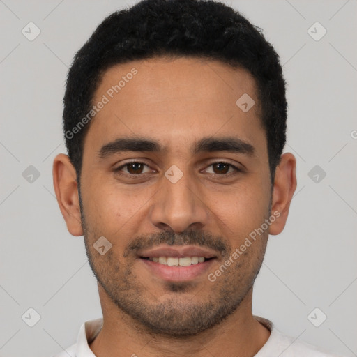 Joyful latino young-adult male with short  black hair and brown eyes