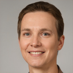 Joyful white adult male with short  brown hair and grey eyes