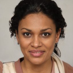 Joyful black young-adult female with medium  brown hair and brown eyes