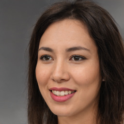 Joyful asian young-adult female with long  brown hair and brown eyes