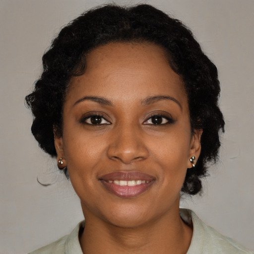 Joyful black young-adult female with medium  brown hair and brown eyes
