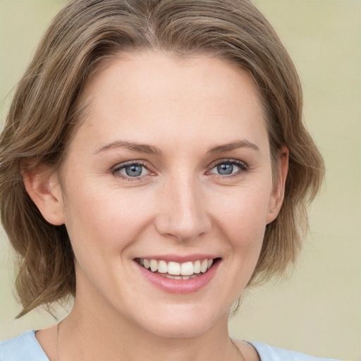 Joyful white young-adult female with medium  brown hair and green eyes