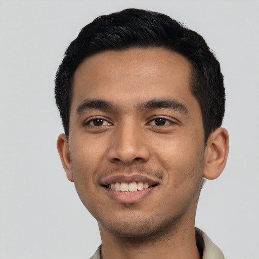 Joyful latino young-adult male with short  black hair and brown eyes