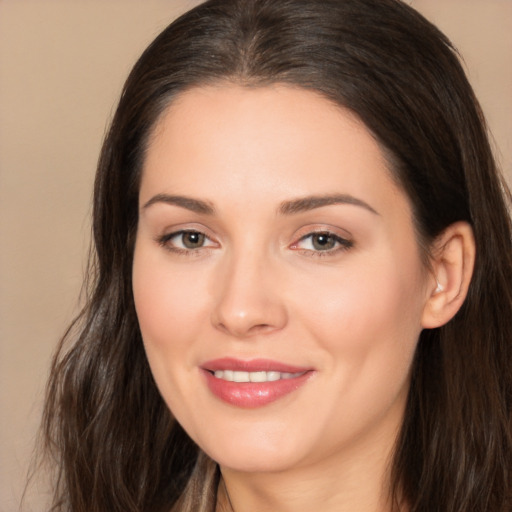 Joyful white young-adult female with long  brown hair and brown eyes