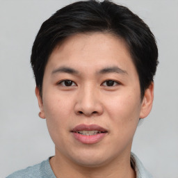 Joyful asian young-adult male with short  black hair and brown eyes