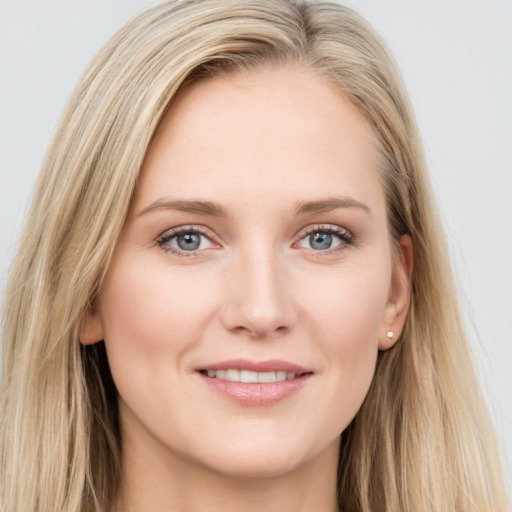 Joyful white young-adult female with long  brown hair and blue eyes