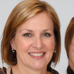 Joyful white adult female with medium  brown hair and brown eyes