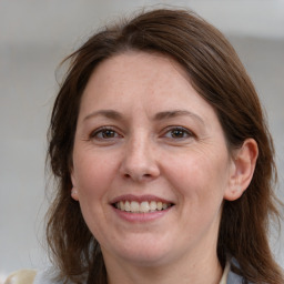 Joyful white adult female with medium  brown hair and brown eyes