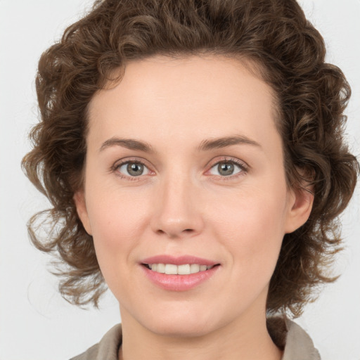 Joyful white young-adult female with medium  brown hair and green eyes