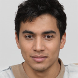 Joyful latino young-adult male with short  brown hair and brown eyes