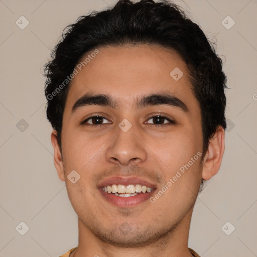 Joyful latino young-adult male with short  brown hair and brown eyes