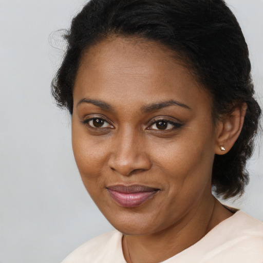 Joyful black young-adult female with medium  brown hair and brown eyes