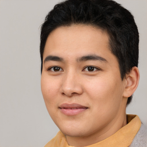 Joyful asian young-adult male with short  black hair and brown eyes