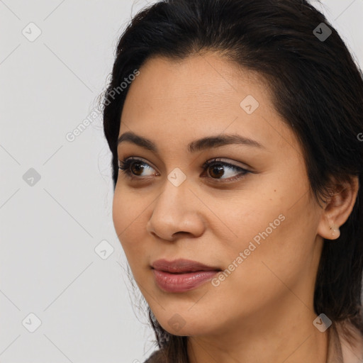 Joyful latino young-adult female with long  brown hair and brown eyes