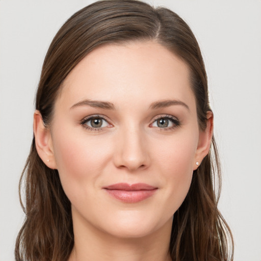 Joyful white young-adult female with long  brown hair and grey eyes