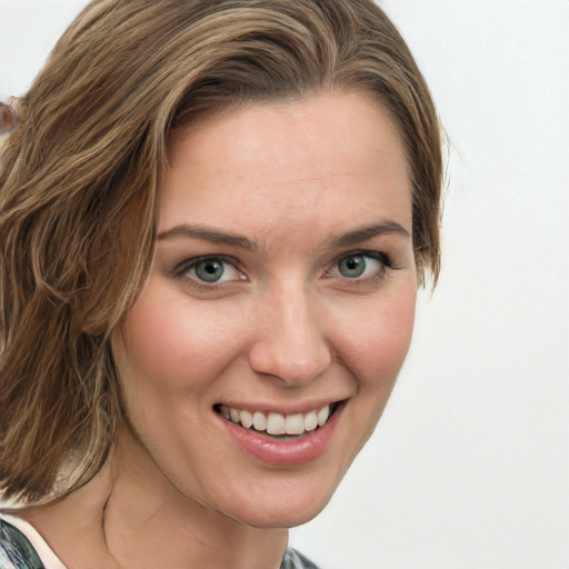 Joyful white young-adult female with medium  brown hair and green eyes