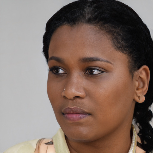 Joyful latino young-adult female with short  black hair and brown eyes