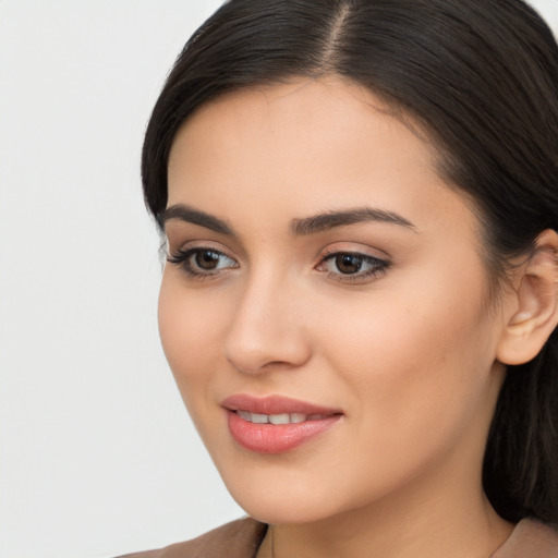 Joyful latino young-adult female with long  brown hair and brown eyes