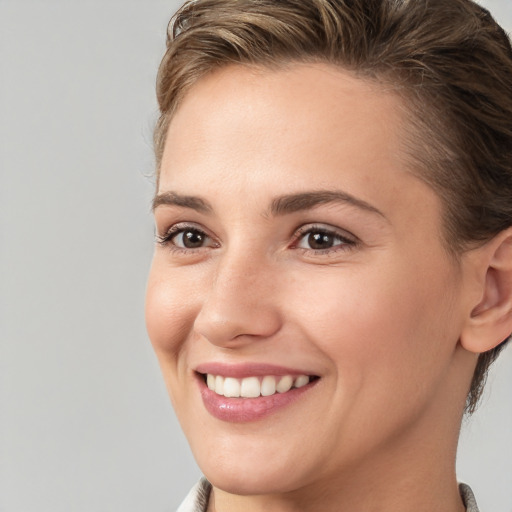 Joyful white young-adult female with medium  brown hair and brown eyes