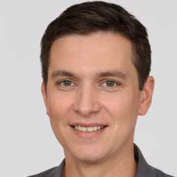 Joyful white young-adult male with short  brown hair and brown eyes