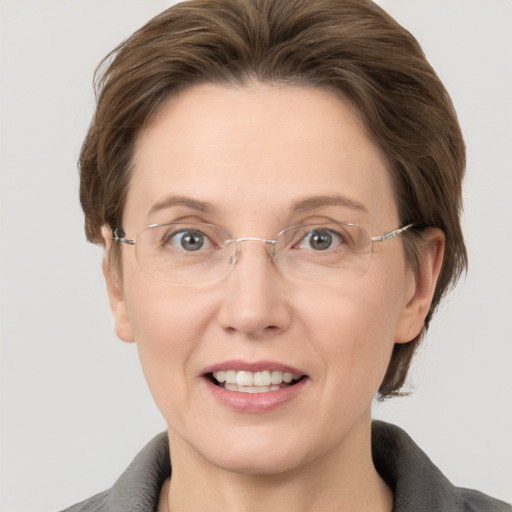 Joyful white adult female with medium  brown hair and grey eyes